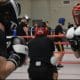 Wedstrijdboksers in actie tijdens een sparringsevent bij Boxing University in Breda, georganiseerd door Team Zuid.
